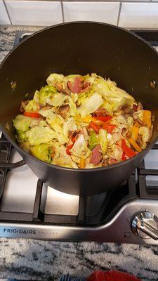 Come get our fried cabbage with vegetables and bacon .