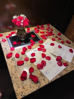 Roses and rose petals on the table when we arrived.