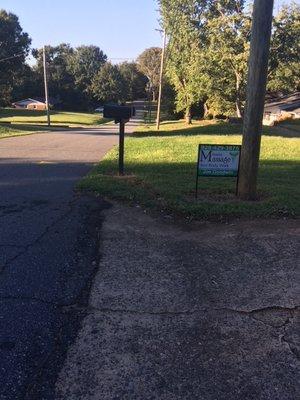 Sign located on Elizabeth Avenue at driveway to parking area.