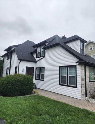 Exterior siding painting and window trim replacement.