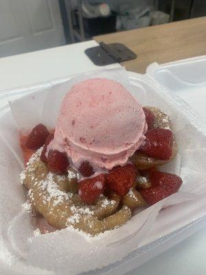 Funnel cake with Strawberries and strawberry ice cream.