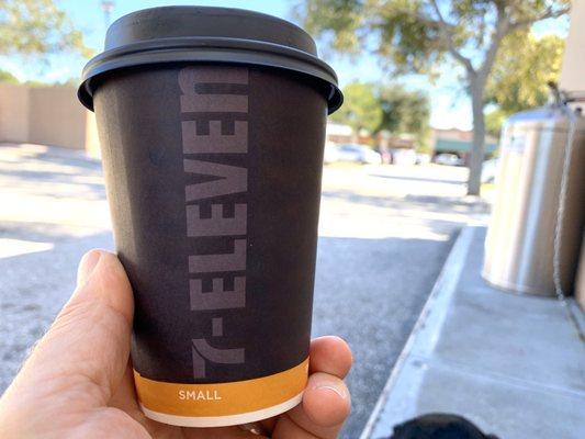 Enjoying a small coffee in the shade of 7-eleven.