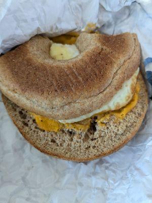 Egg cheese and sausage on a disgusting whole wheat bagel.