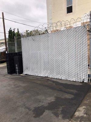 I was driving in when I saw the parking lot looking so clean and organized by their back room near the trash bins and the gate. Nice.