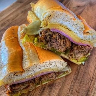 Our Cubano! made with spanish pulled pork, swiss, ham and pickles.