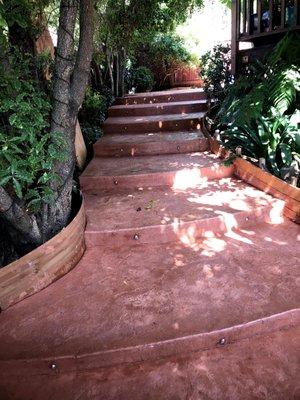 radius steps with terracotta -colored concrete  and stone stamping.*lights on each step.