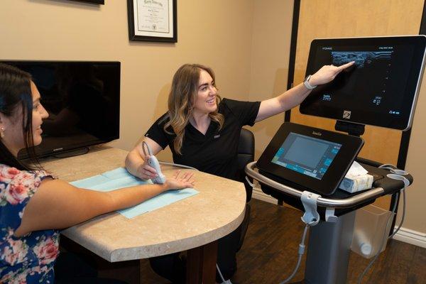 provider performing ultrasound to diagnose common hand conditions in office.