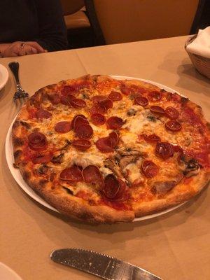 Pizza in the dining room. Personal pizza. Pepperoni mushroom & sausage. The best!