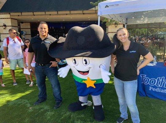 Dr. Eddie Rugama, Tooth in Boots Mascot, and Mrs. Rugama