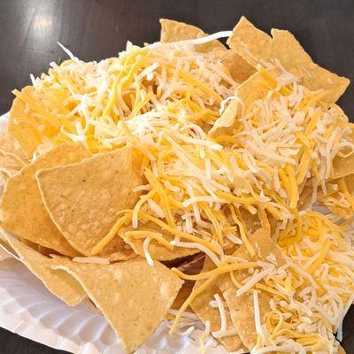 Chips with shredded cheese--it's not melted, so it makes a mess falling off the chips when you grab them.