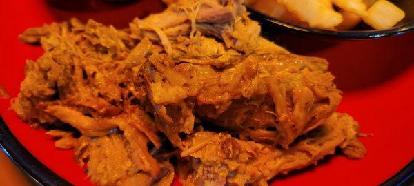 Pork with a terrible plate choice.  The red plate didn't help the appearance of the food at all