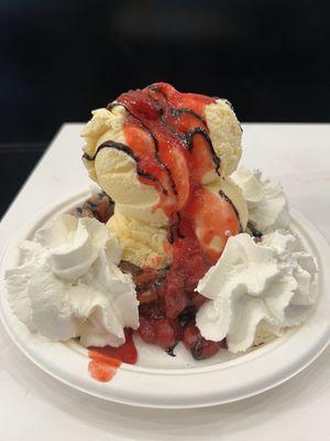 Churro Sundae  vanilla icecream, strawberry topping, light chocolate sauce, whipped cream