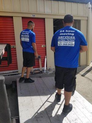 Movers moving belongings from a storage unit