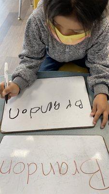 Practice and patience while learning to write his name.