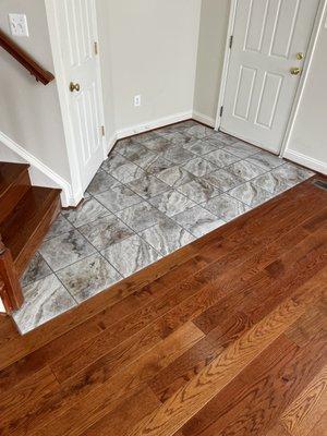 Ceramic tile installed in foyer with hardwood floors installed all throughout main floor.