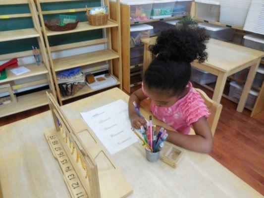 Using the hanging bead stair (teens), this pre-school aged friend works on understanding number quantities.