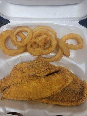 Fried tilapia with onion rings.