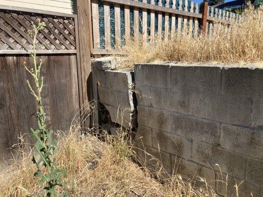 Failed poured concrete retaining wall.