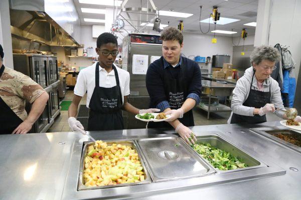 Volunteers plating food at Blanchet House.