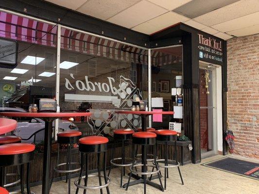 High top tables looking out front windows to the Main Street.