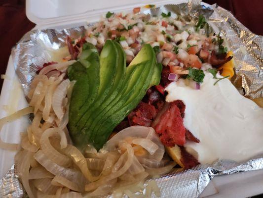 Trompo fries, grilled onions, pico, sour cream, avocado, and queso