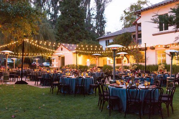 As the sun sets the lights illuminate the outdoor reception space.