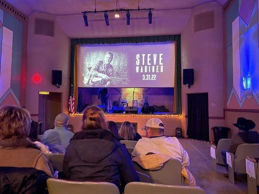 Stage with screen down prior to show. This was row G in the center.