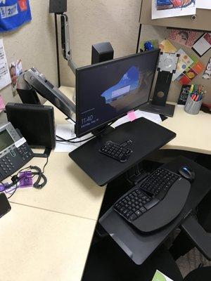 Employee has a large desk area and the Workfit A Sit and Stand can be swiveled out of the way to leave workspace.