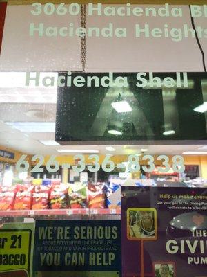 Photo of front of store window with contact information.