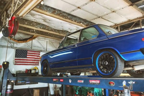 My car up on the lift getting a new muffler installed.