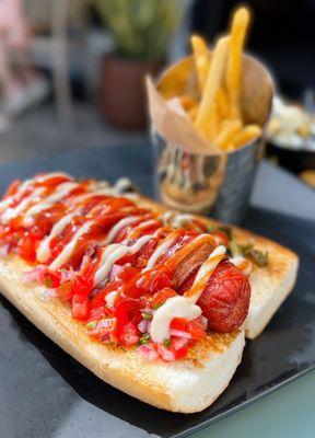 Classic Street (Dirty) Dog: All beef hotdog wrapped in bacon, aioli, grilled peppers, onions, pico de gallo, ketchup, fries | $11