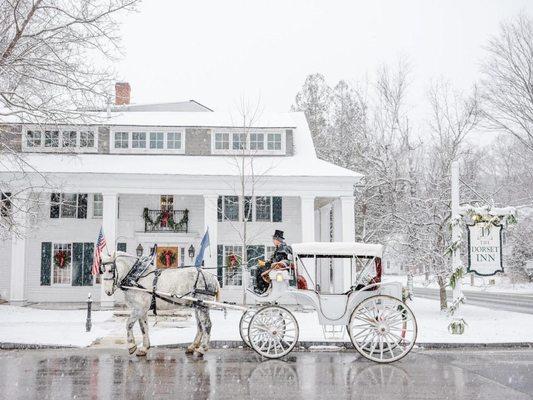 Photo of horse being used to pull carriage by driver in front of Dorset Inn while snowing