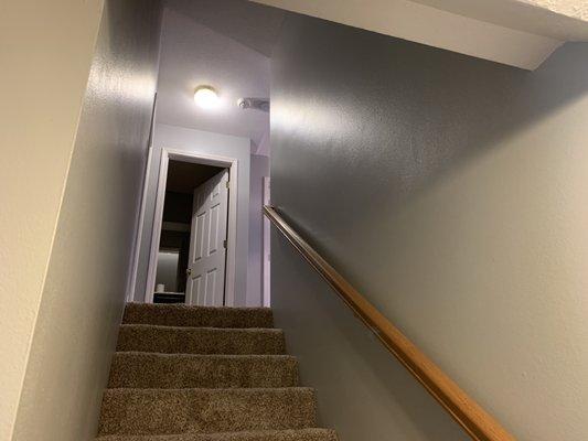 Finished stairwell after 200 +/- repairs, 2-3 coats each, 2 top coats of Behr Ultra Scuff Defense Satin. Homeowners love it!