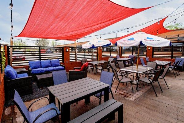 Covered patio with brand new tables and chairs as well as some comfortable couches!