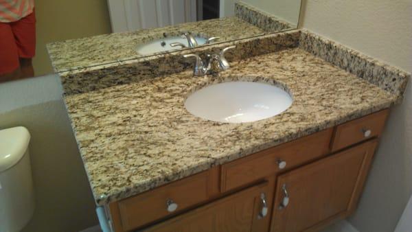 Granite from old kitchen moved to bathroom.