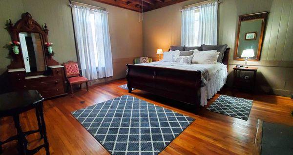 The General Easley is a spacious corner guest room that boasts a king sleigh bed.  It has a ceiling fan, Roku tv, and a private bathroom.