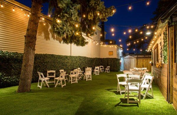 Atlantis Hall Backyard night time cocktail setup with string lights