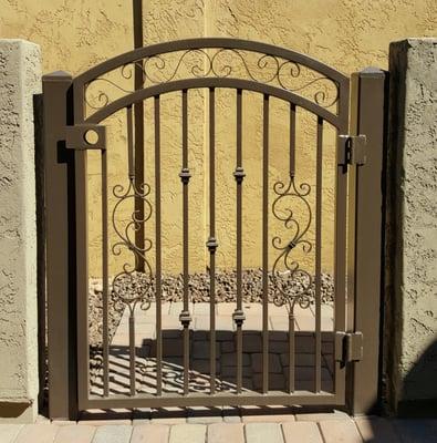 Court yard gate with arched double rails, scrolls and knuckles.