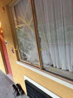 Broken window with someone staying in it