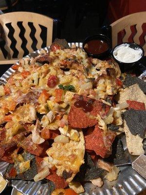 Chicken nachos with a nice house BBQ sauce and sour cream. Tons of plain chips buried in the middle.