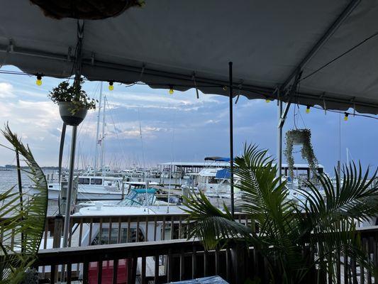 Situated on the harbor the covered decks face the boat docs. Inside dining is also available.