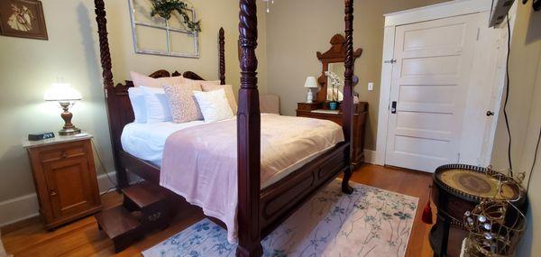 The L'Amour is a cozy  guest room with a gorgeous poster bed, ceiling fan, Smart tv, and private bathroom.