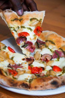 La Genovese - garlic, olive oil, roasted garlic, fresh mozzarella, sweet peppadew peppers, coppa ham, pesto drizzle.