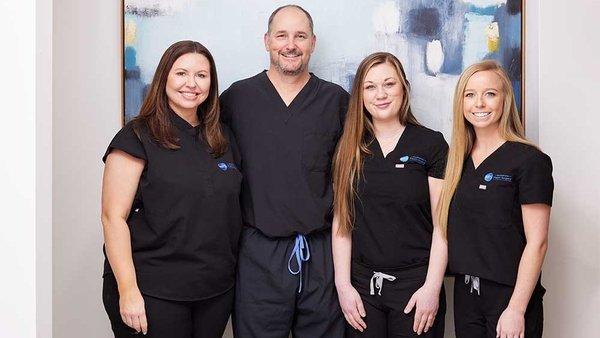 Mark Morgan, MD, FACS, with his plastic surgery team of nurses and operation room staff in Wilmington, North Carolina.