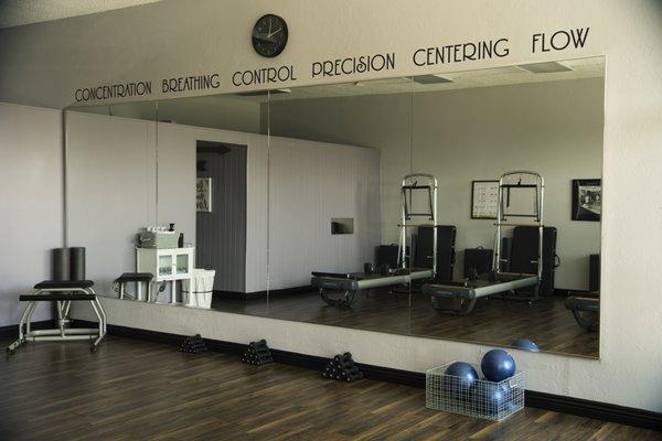 The six Pilates principles are stenciled above our large mirrors, reminding you to be mindful in your workout.