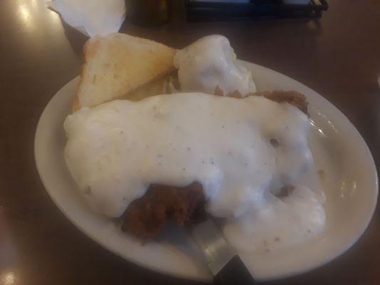 Half Portion of Chicken Fried Steak with mashed potatoes and buttered toast.