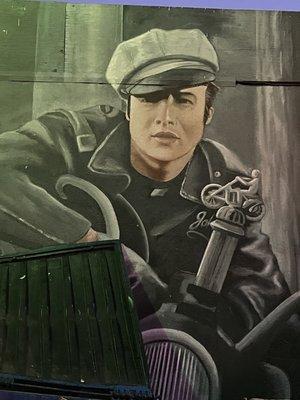 Cool Marlon Brando Wall Mural black leather jacket, hat on a motorcycle from The Wild One movie near the trash Container Santa Monica/Wilton