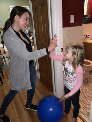 Samantha Allen, founder of NYC Potty Training, helps a child learn to use the toilet.