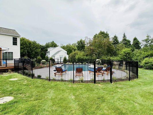 This is a 5' tall aluminum 3 rail fence that meets pool code.  A beautiful accent to this new swimming pool.