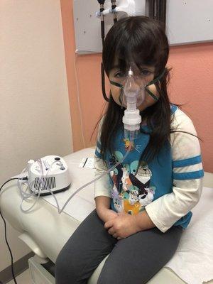 Breathing treatment time. Her first time and she was very scared, but she was going to feel better soon!